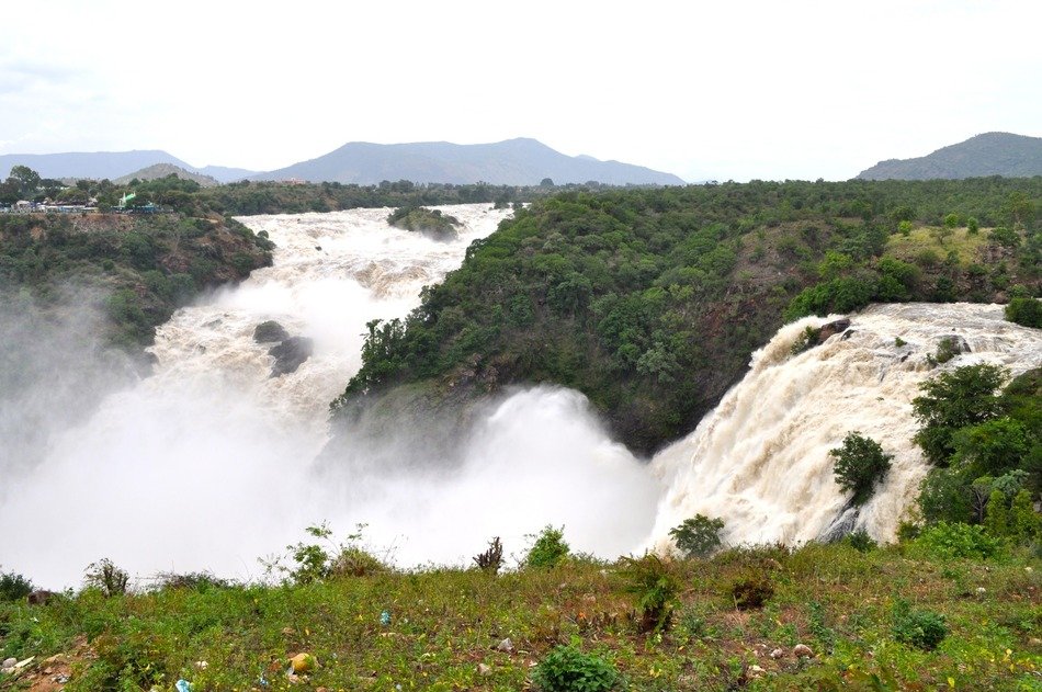 stormy waterfalls among green vegetation