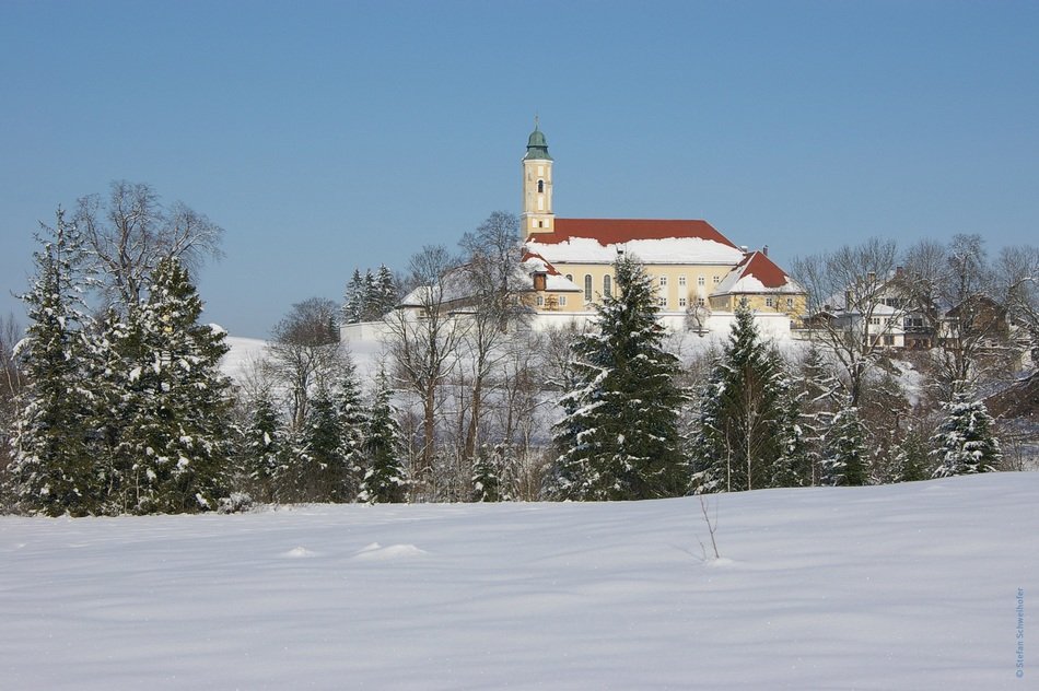 photo of monastery in the forest in winter