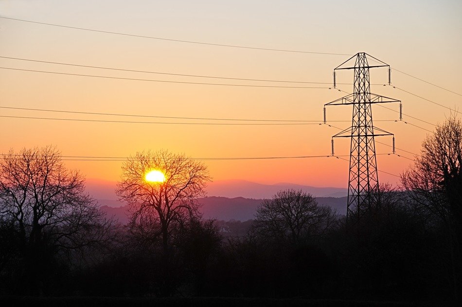 View of the sunset behind the electric pillars