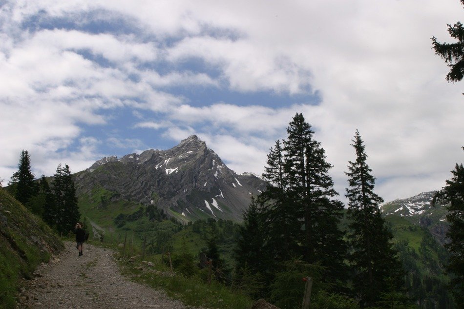 man walking on the trail on the background of beautiful scenery of Austria