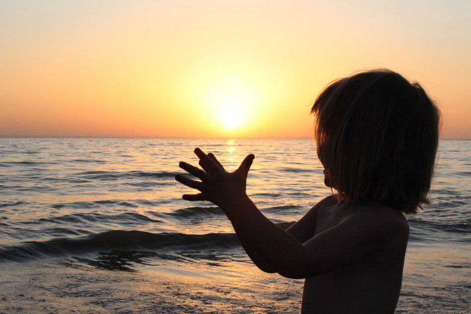 silhouette of a child at sunset