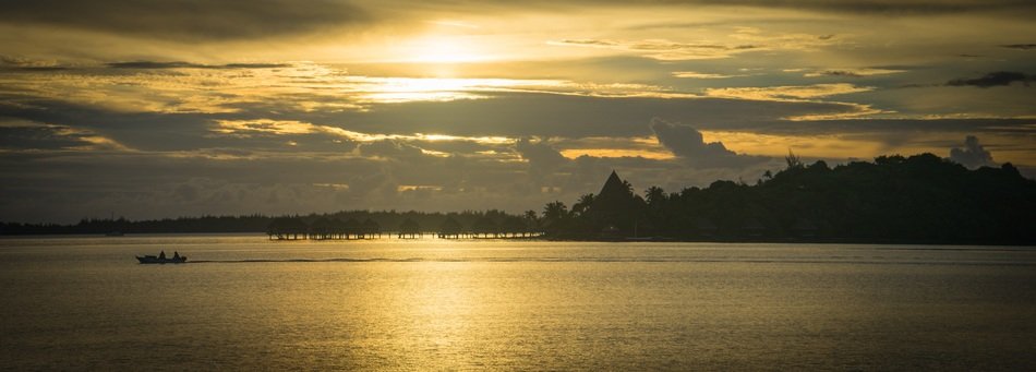yellow sunset over the coast of the island of bora bora