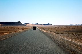 car on the highway in the desert of Morocco