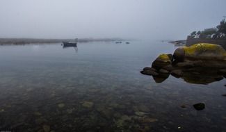 boat on the water in the fog