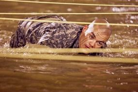 soldier under the wire in the water