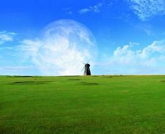 Landscape of lonely windmill in a green field