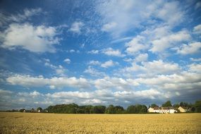 landscape of blue sky in the clouds with a village