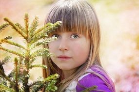 photo of the girl near the Christmas tree