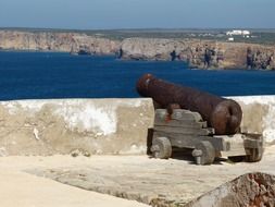 rusty cannon on a beach in Portugal