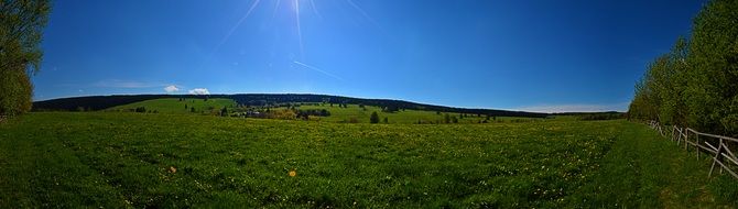 green field blue sky panorama