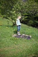 little girl standing near fireplace nature