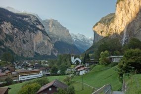 Beautiful small town among the green plants in the swiss alps