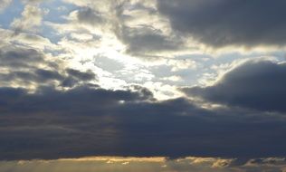 sunburst through the clouds in the sky