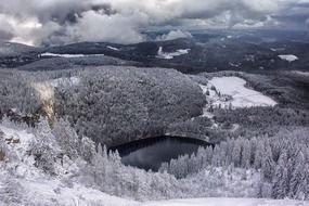 landscape with dark scenic forest and a lake