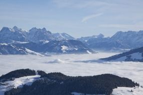 mountain peaks above the clouds in winter