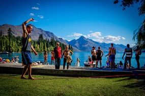 landscape of young people relaxing by the water in new zealand