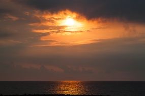 red sun through the clouds at sunset