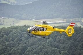 yellow helicopter in flight