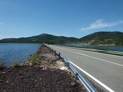 road through the lake to the mountains