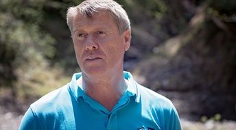 gray-haired man in a blue t-shirt