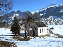 Beautiful chapel in mountains in snow in Switzerland