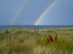 double rainbow above green field, denmark