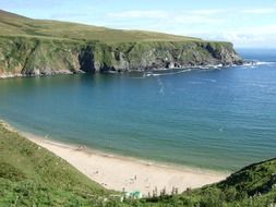 beautiful beach with green banks in Ireland