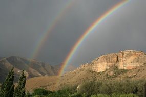 rainbow over the mountains in summer