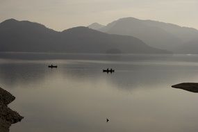 fishermen on boats on the lake