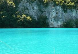 Lake with blue water near the cliff