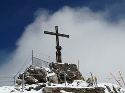 cross on top of a snowy mountain