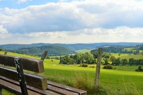 Wooden bench green field landscape