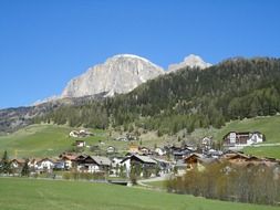 village at the foot of dolomites mountains