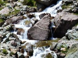 water cascade among large stones on a sunny day