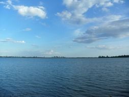 Blue sky with white clouds over the lake