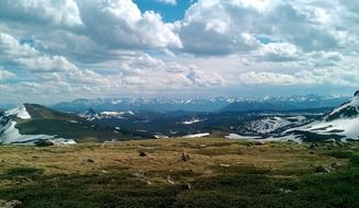 large white clouds over a mountain landscape