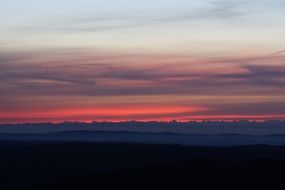 distant view of alpine mountains at sunset