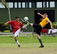 Football players play on the field in Colombia