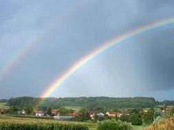 rainbow over the village among nature