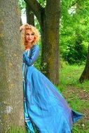 girl in a blue dress in the forest