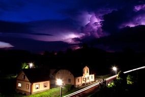 Beautiful, violet stormy sky over the houses and fields