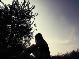 Girl is sitting on the grass
