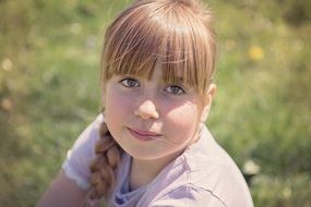 girl child face portrait in the meadow