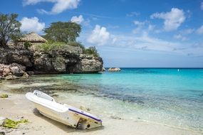 White boat on the beautiful, sandy beach coastline on Curacao