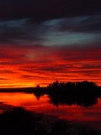 Crimson sunset at dusk over the lake