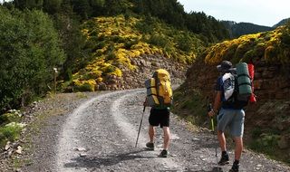 people with backpacks walking on mountain trail, spain, ordesa national park