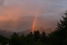 rainbow in the evening sky over the mountains