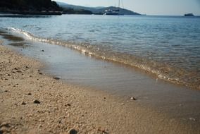 sea waves on a sandy beach close up