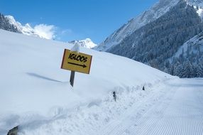 sign in the snowy mountains with the inscription igloo