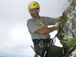 portrait of mountaineer in a yellow helmet